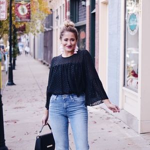 Sheer black blouse with flared sleeves